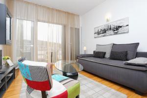 a living room with a couch and a glass table at Apartments by the sea Trogir - 16210 in Trogir