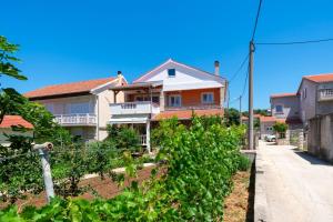 a house on the side of a street at Apartments with a parking space Bibinje, Zadar - 16188 in Bibinje