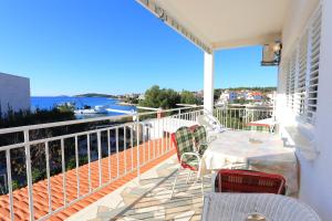 a patio with a table and chairs on a balcony at Apartments by the sea Rogoznica - 16216 in Rogoznica
