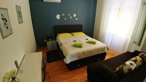 a small bedroom with a bed and a couch at Apartments by the sea Brgulje, Molat - 16217 in Molat