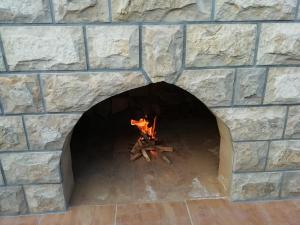 a brick oven with a fire in it at Apartments with a parking space Luka, Peljesac - 16229 in Ston