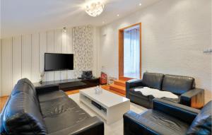 a living room with two leather couches and a tv at Cozy Home In Krizevci With House A Panoramic View in Križevci
