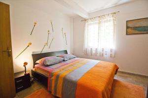 a bedroom with a bed with flowers on the wall at Apartments with a parking space Split - 16247 in Split
