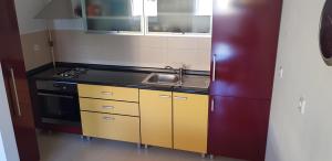 a small kitchen with a sink and a refrigerator at Apartments with a parking space Krapinske Toplice, Zagorje - 16290 in Krapinske Toplice