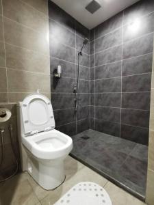 a bathroom with a toilet and a shower stall at deCore in Kota Kinabalu