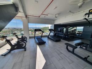 a gym with several treadmills and a large window at deCore in Kota Kinabalu