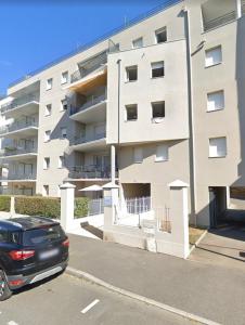 a black car parked in front of a building at L'Effet-Mer - Tout équipé - Parking Privé - Wifi in Saint-Nazaire