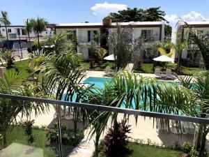 a view of a resort with a swimming pool at Boca Paraiso, Boca Chica townhouse in Boca Chica