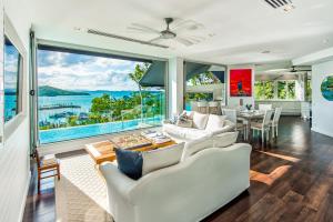 a living room with a view of the ocean at Habitat on Hamilton Island by HIHA in Hamilton Island