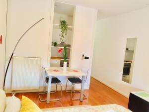 a small white table and chairs in a room at Apartments with WiFi Zagreb - 16284 in Zagreb