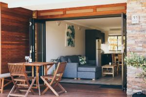 a living room with a couch and a table at The Anchorage Bermagui in Bermagui