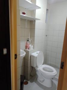 uma casa de banho com um WC branco e um lavatório. em Affordable Condo for Rent in Valley Mansions em Cainta