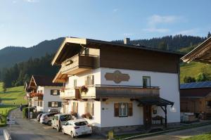 a building with cars parked in front of it at Appartement Ingrid in Ellmau