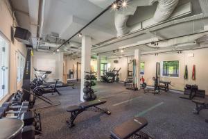 a gym with lots of exercise equipment in a room at Amara Sanctuary Sentosa in Singapore