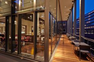a view of a restaurant with tables and chairs at AMERON Hamburg Hotel Speicherstadt in Hamburg