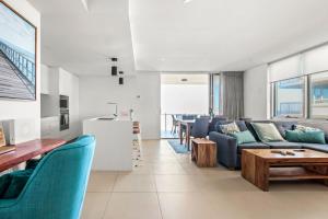 a living room with a couch and a table at Aquaview Unit 304 Kings Beach in Caloundra