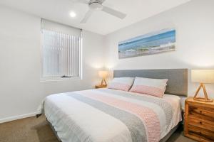 a bedroom with a bed and a window at Aquaview Unit 304 Kings Beach in Caloundra