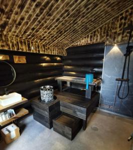a room with a desk in a room with black walls at Heteranta, Lake Inari / Inarijärvi in Inari +12 photos