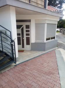 a house with a brick driveway in front of it at Apartments with a parking space Jusici, Opatija - 15874 in Kastav