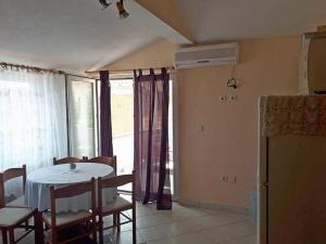 a dining room with a table and chairs and a window at Apartments by the sea Nin, Zadar - 15842 in Nin