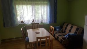 a living room with a table and a couch at Apartments with a parking space Covici, Velebit - 15864 in Otočac