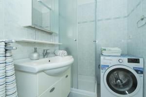 a bathroom with a washing machine and a sink at Apartments with WiFi Split - 15862 in Split
