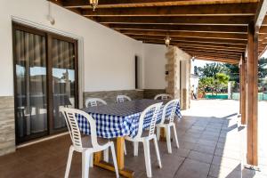 a table and chairs on the patio of a house at Reel Paradise Villa, Cyprus in Larnaca