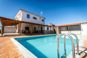 a swimming pool in front of a house at Reel Paradise Villa, Cyprus in Larnaca