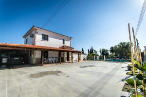 a house with a large driveway in front of it at Reel Paradise Villa, Cyprus in Larnaca