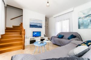 a living room with a couch and a table at Reel Paradise Villa, Cyprus in Larnaca