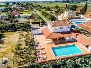an aerial view of a house with a swimming pool at Reel Paradise Villa, Cyprus in Larnaca