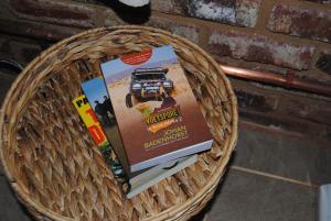 a wicker basket with books on top of a brick wall at Grotto to Gravel in Magaliesburg