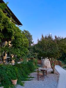 a table and chairs in a garden next to a building at B&B La Fucinaia Pet Friendly Adults only in Campiglia Marittima