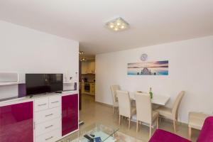 a living room and dining room with a dining table at Apartment Vodice 16249b in Vodice