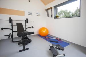 a room with a gym with a ball and weights at Apartments with a swimming pool Razanj, Rogoznica - 16182 in Rogoznica