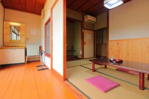 an empty room with a table and a kitchen at ootaryokan in Kuroki