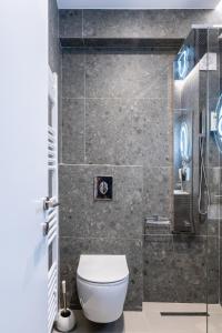 a bathroom with a toilet and a shower at Empress Luxury Residences in Volos