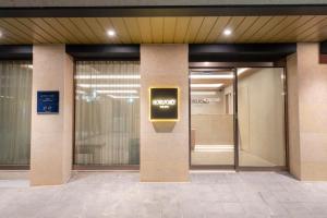 an elevator in a building with a sign on it at Hotel Foret The Spa in Busan