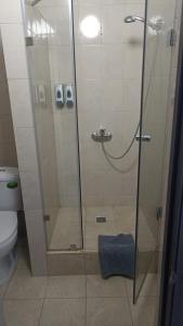 a shower stall in a bathroom with a toilet at Rush Hotel in Atyraū
