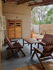 two chairs and a picnic table on a patio at Abaloo Apartment #1 in Sabie