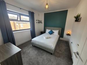 a small bedroom with a bed and a window at Luke Stays - Parsons Gardens in Dunston
