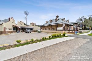 a building on a street with a parking lot at Hilldo in Kurrajong