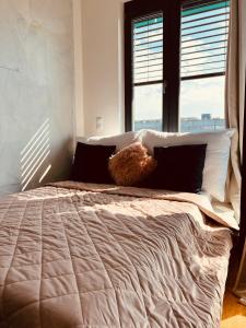 a large bed in a bedroom with a window at White Pearl Studio with parking in Holešovice in Prague