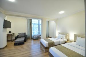 Postel nebo postele na pokoji v ubytování Madin Eco Hotel