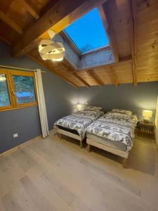 Schlafzimmer mit einem Bett und einer Decke mit einem Fenster in der Unterkunft Chalet le Lotus Blanc in Les Deux Alpes