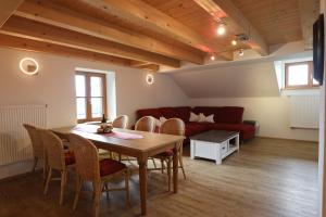 a living room with a table and chairs and a couch at Grüntenblick in Weitnau