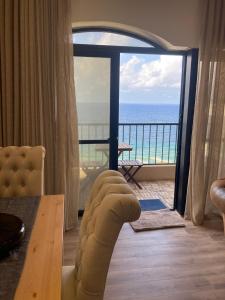 a living room with a view of the ocean at Beach front High End apartment, direct sea views. in Marsalforn