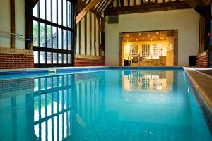 a large swimming pool in a building at Finest Retreats - Puddleduck 