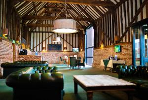 a large room with couches and tables in a building at Finest Retreats - Puddleduck 