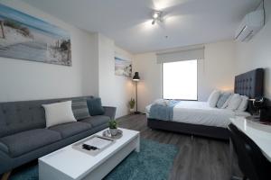 a living room with a couch and a bed at 206 Funky Executive Studio Cbd Ac in Perth